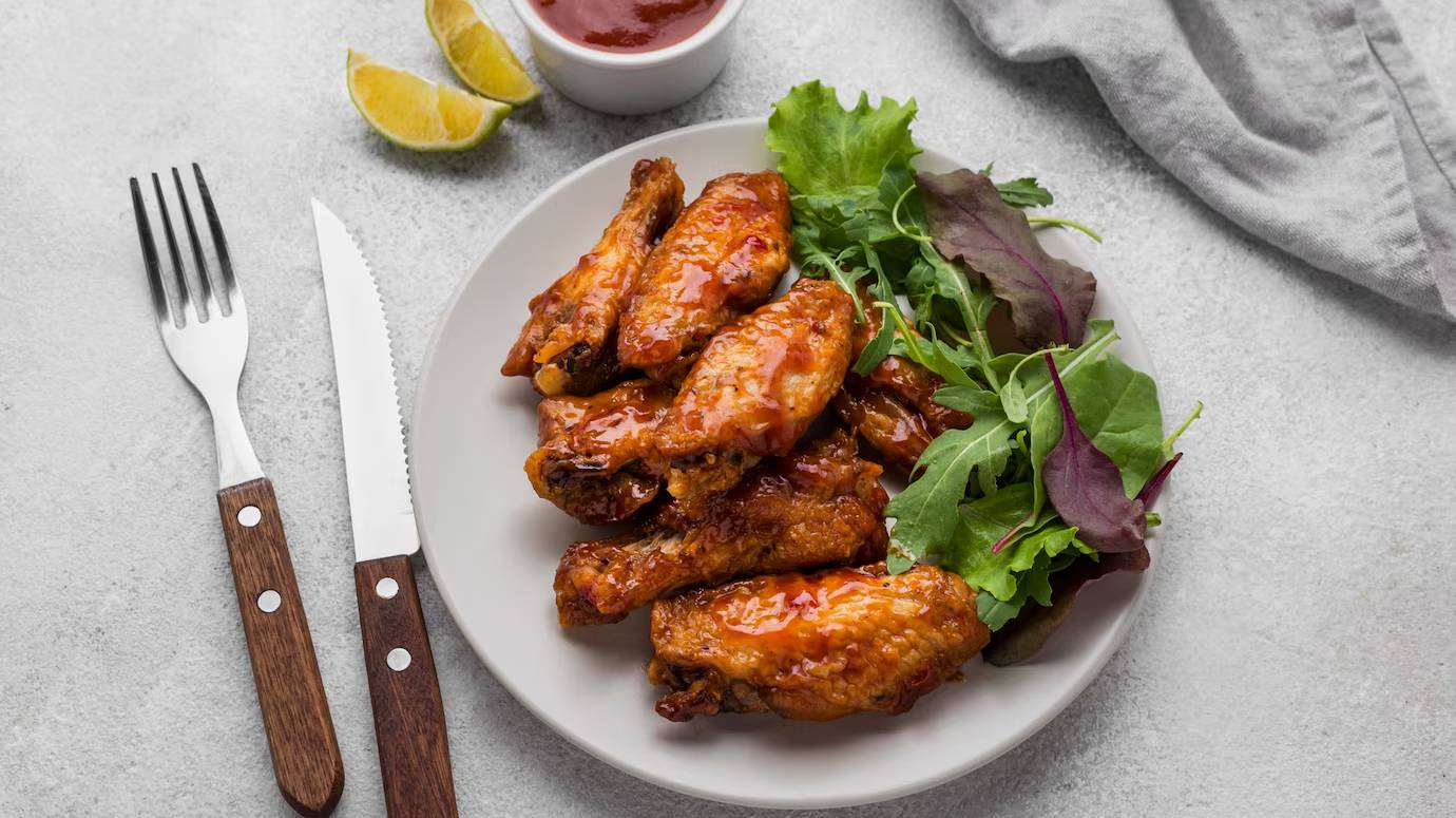 high-angle-plate-with-fried-chicken-salad-with-sauce-cutlery_23-2148646615