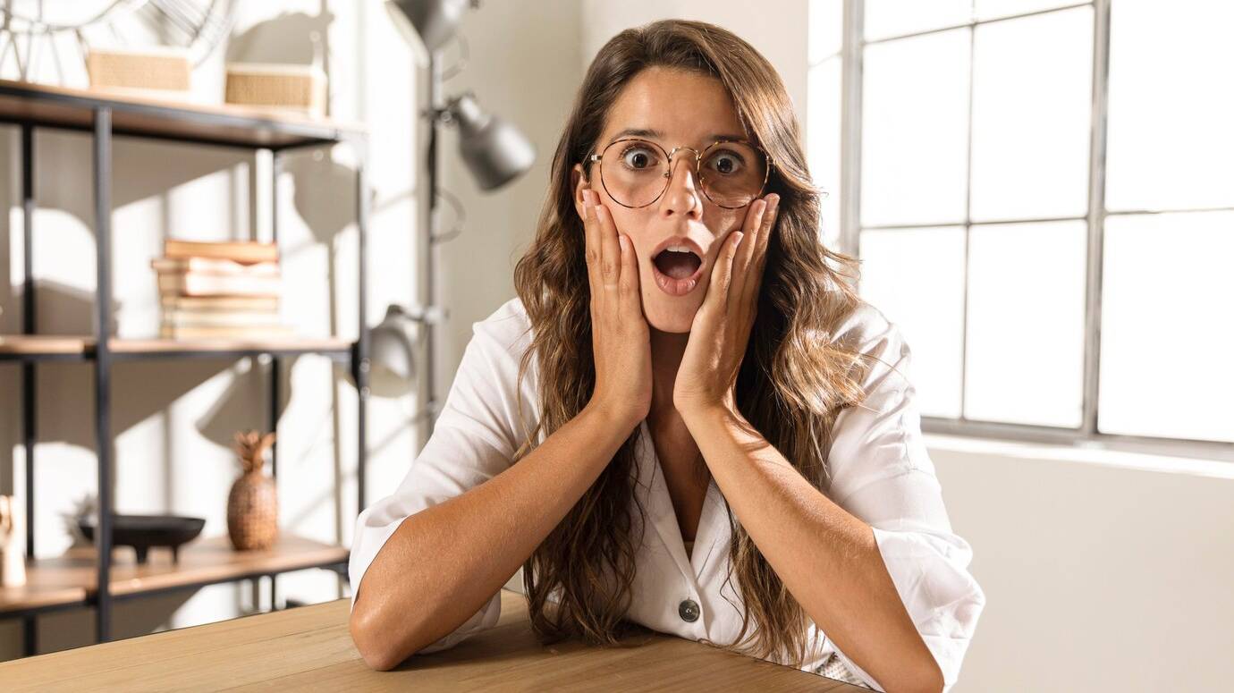 mid-shot-surprised-woman-table_23-2148751515