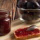 plums-with-jar-confiture-toast-bread_114579-19496