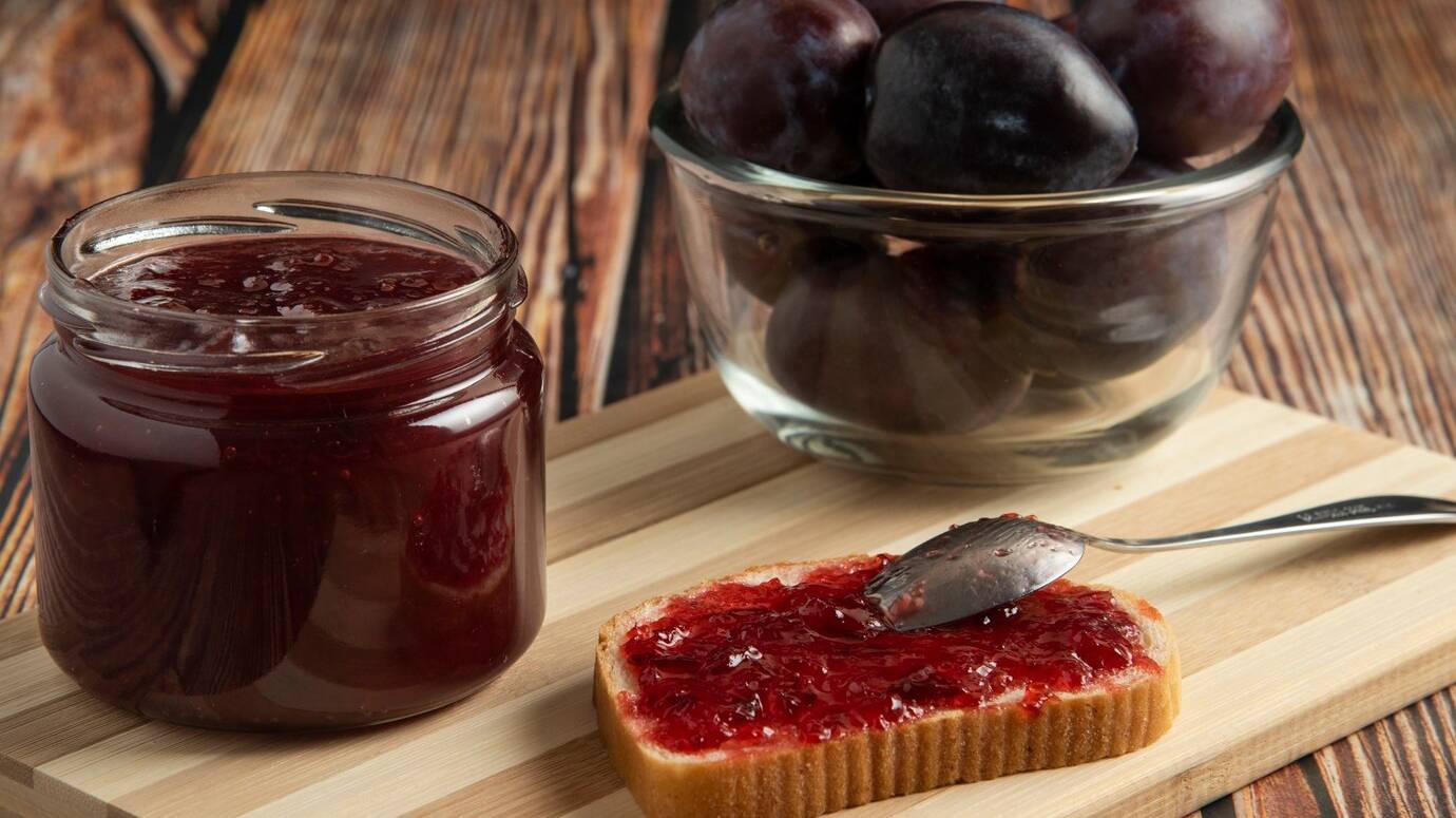 plums-with-jar-confiture-toast-bread_114579-19496