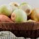 side-view-onions-basket-plaid-cloth-white-background_141793-9453