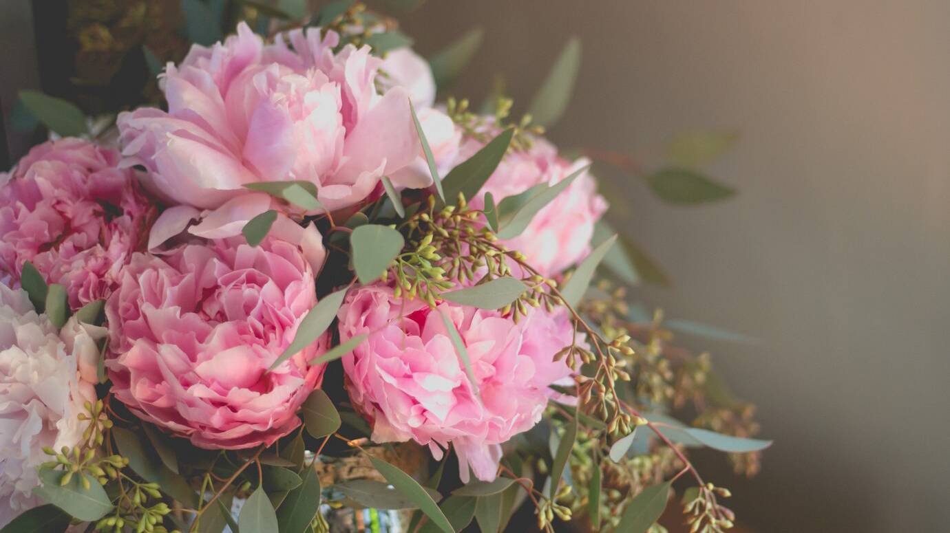 closeup-shot-bouquet-pink-roses-other-flowers-with-green-leafs_181624-3255