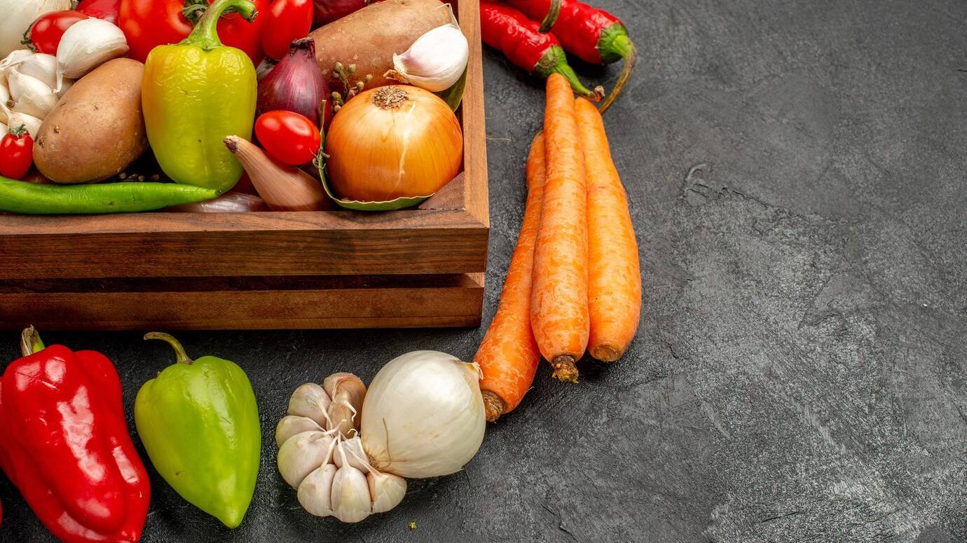 front-view-fresh-vegetables-with-pepper-garlic-dark-table-ripe-salad-color-health_140725-124767