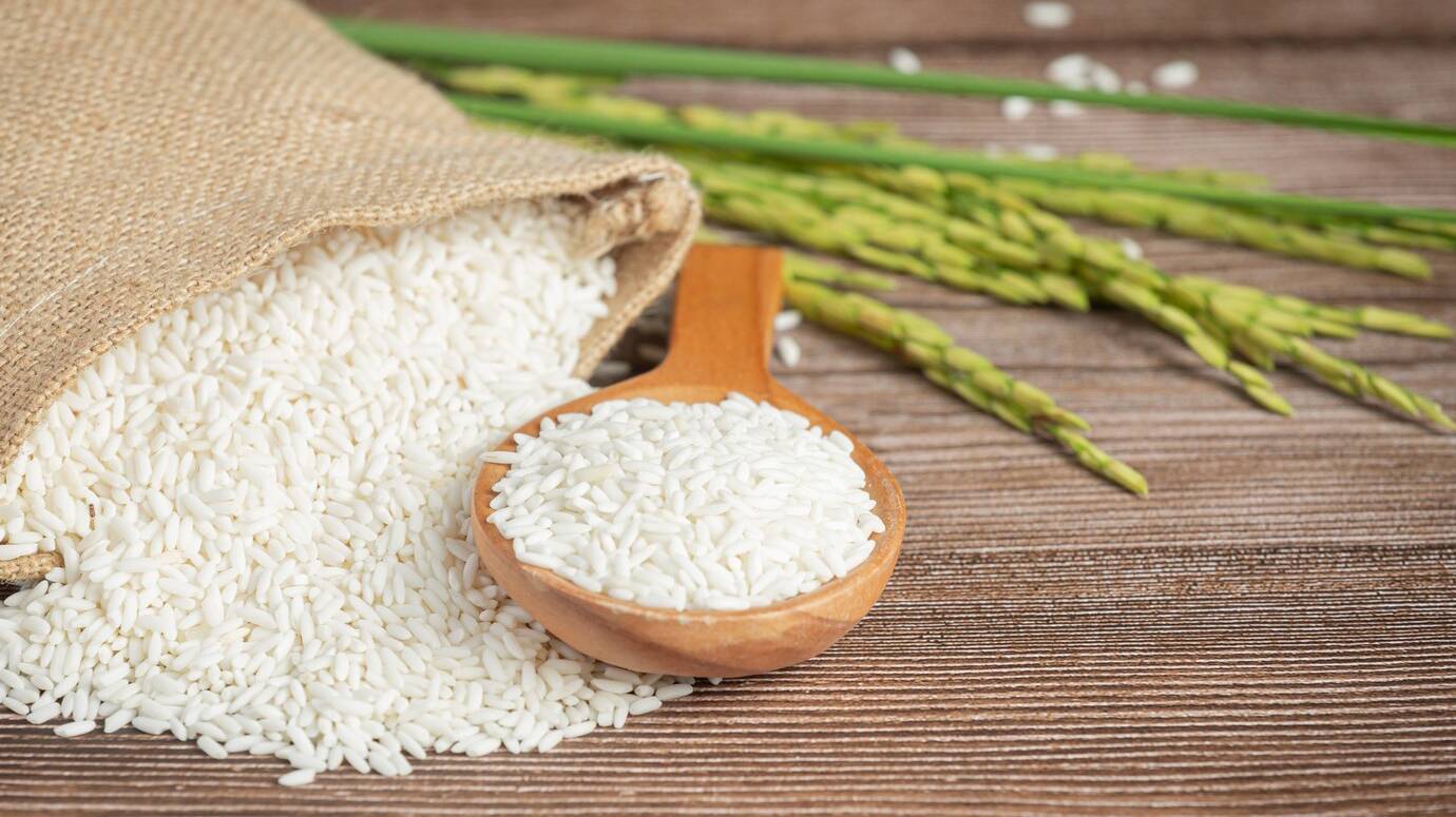 sack-rice-with-rice-wooden-spoon-rice-plant_1150-34312