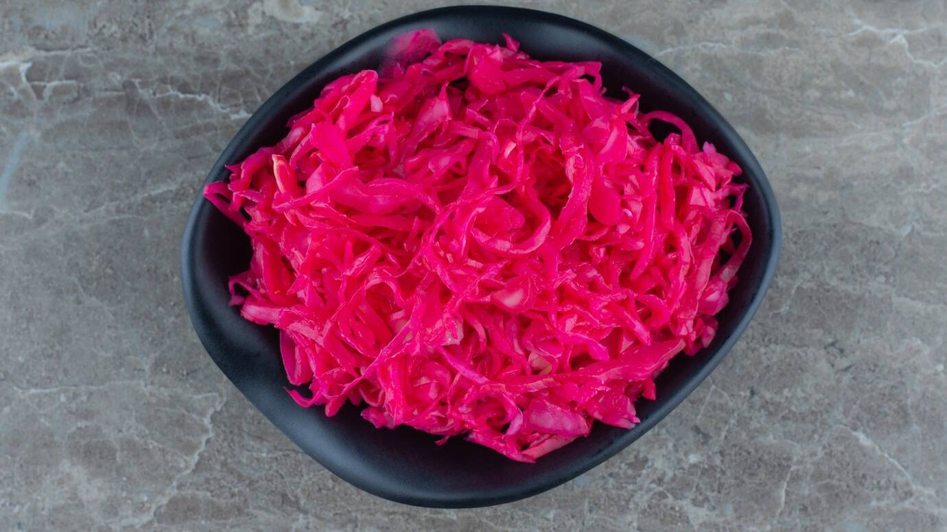 top-view-pink-sauerkraut-black-bowl_114579-82958