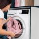 woman-taking-clothes-from-washing-machine_23-2149117037