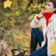 young-woman-autumn-park-sitting-log_1303-11485