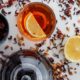 brewed-tea-with-dried-herbs-lemon-glass-teapot-white-surface_176474-6309