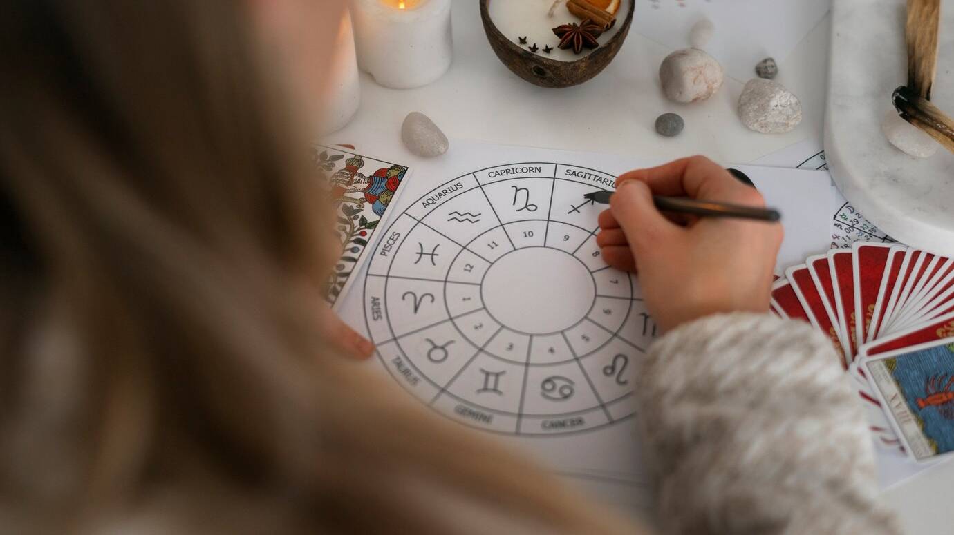 high-angle-woman-reading-tarot-home_23-2150276062