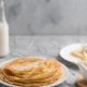 pancakes-plate-with-milk-bottle_23-2148531625