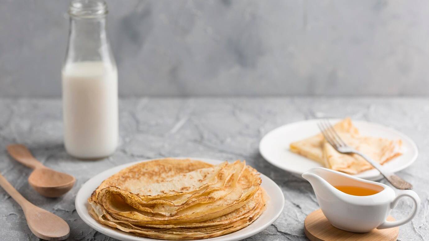 pancakes-plate-with-milk-bottle_23-2148531625