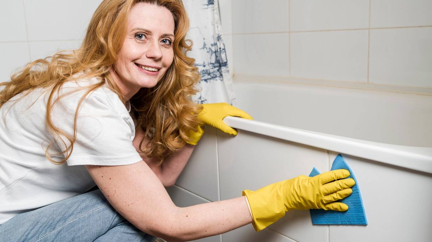 side-view-woman-cleaning-bathtub_23-2148465063