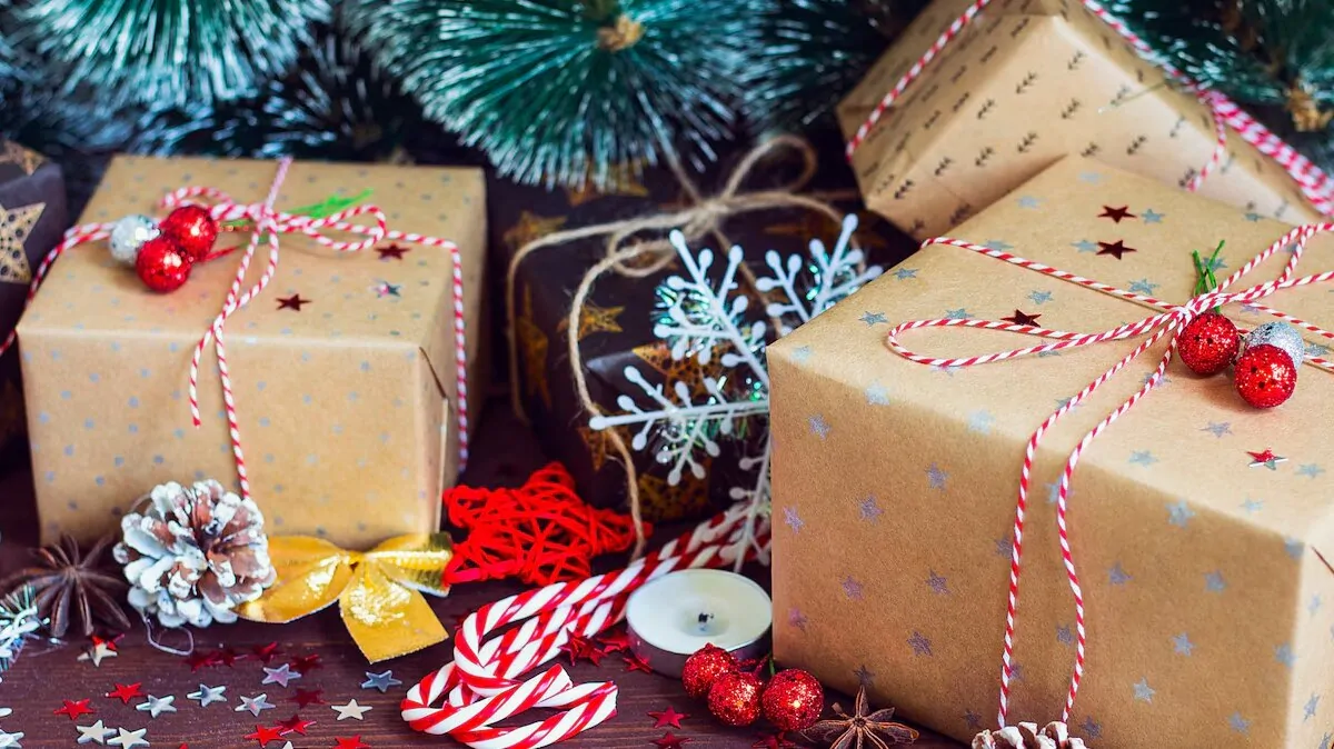 christmas-holiday-gift-box-decorated-festive-table-with-pine-cones-fir-branches_114579-607