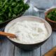 front-view-cucumbers-board-with-yogurt-greens-gray-surface_141793-17671