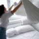 woman-making-bed-medium-shot_23-2149042030