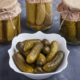 pickled-cucumbers-bowl-glass-jars-blue-surface_114579-14693