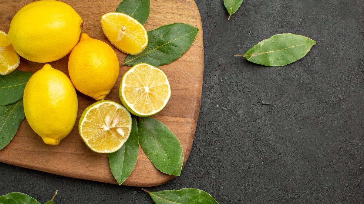 top-view-fresh-lemons-sour-fruits-dark-table-citrus-fruit_140725-81409